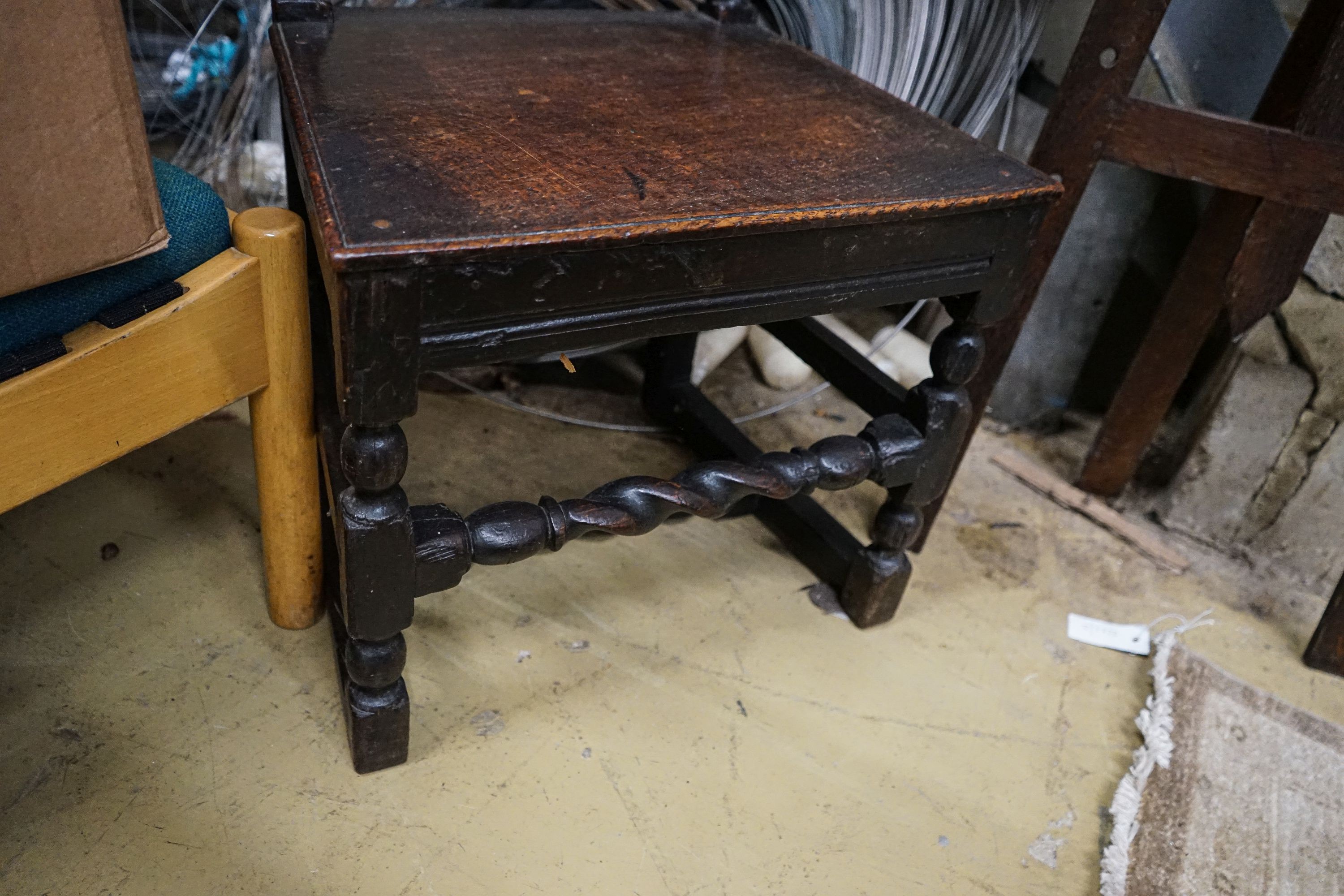 A 17th century oak dining chair, with carved panelled back, solid seat and barley twist stretchers, width 49cm, depth 39cm, height 96cm